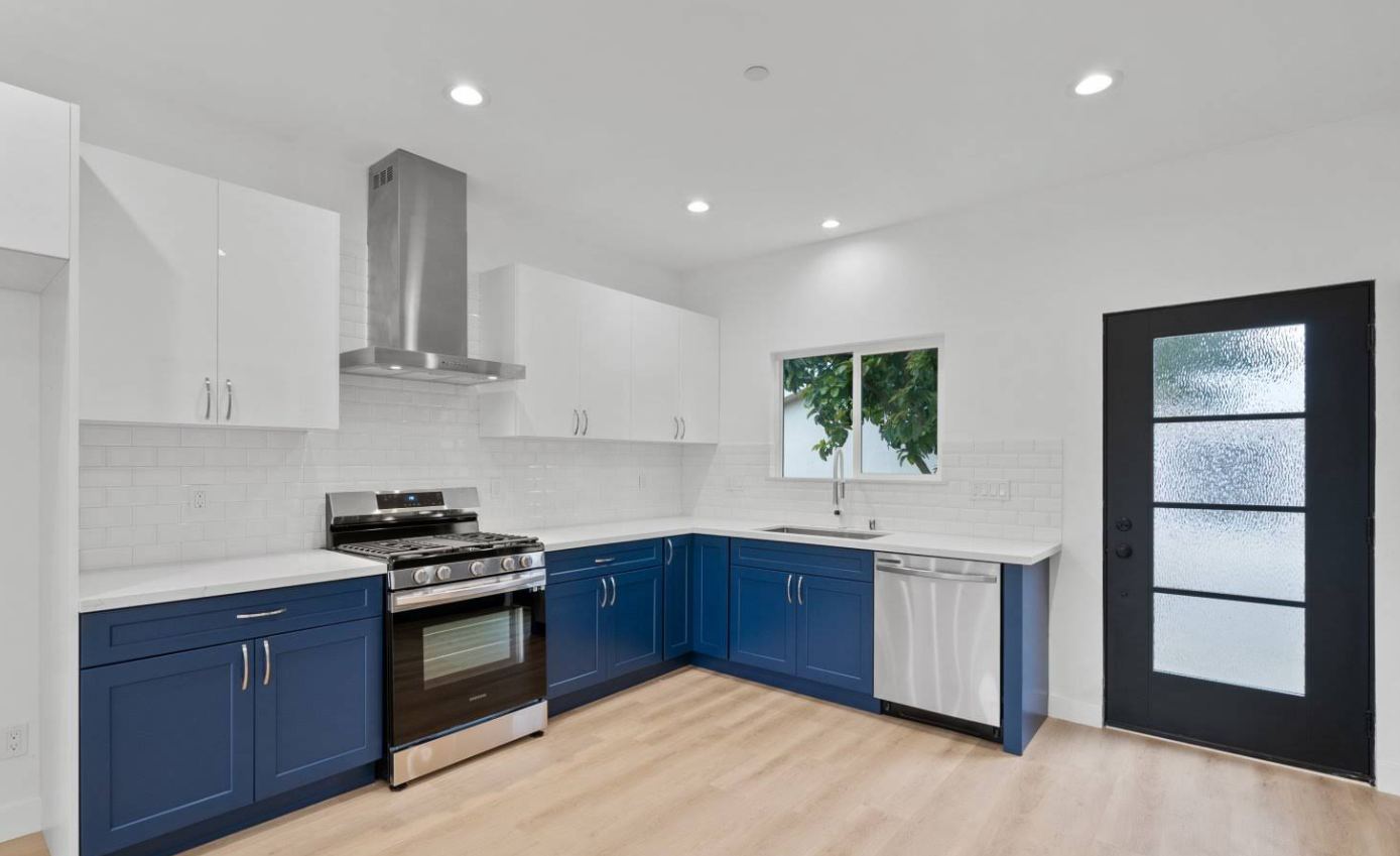 Two-tone navy and white kitchen with subway tile backsplash