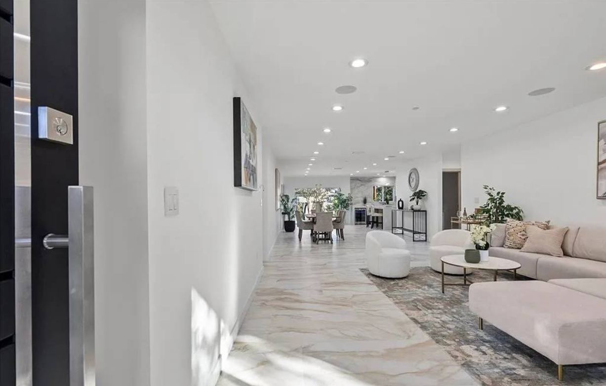 Open living space with marble floors after full remodel